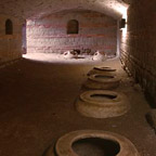 The basement with large storage vessels in the ground.