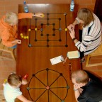 Family playing a Roman board game.