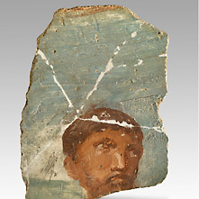 Een Romeinse muurschildering met het portret van een man met baard. 