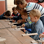 Two students carving bones during the Roman Weekends.