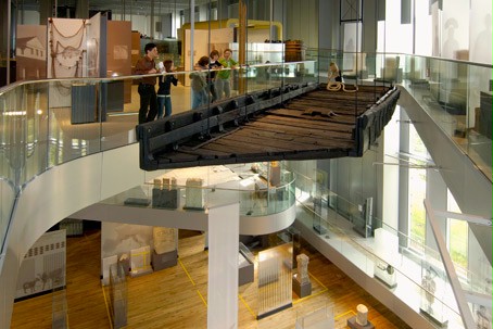 A Roman ship is suspended from the ceiling of the RömerMuseum.