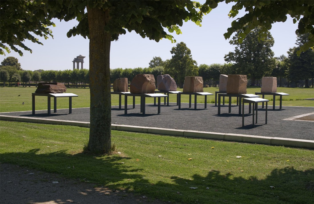 Eight large stones of various kinds on iron tables in the open air