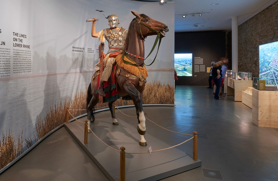 Ansicht der Landesausstellung, Figurine eines batavischen Reiters zu Pferde, Vitrinen unscharf im Hintergrund